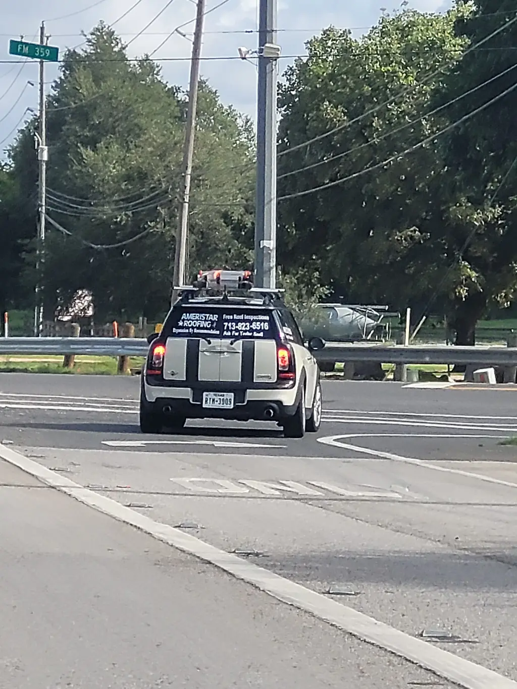 Ameristar Roofing branded service vehicle on the road in Fort Bend County